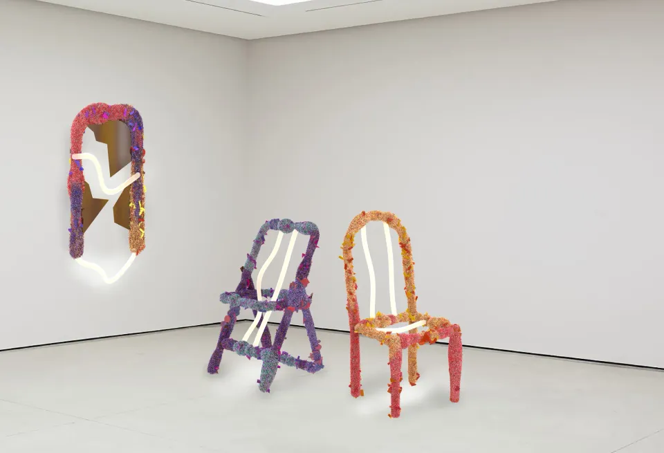 Two Rottame chairs and a mirror in the exhibition space
